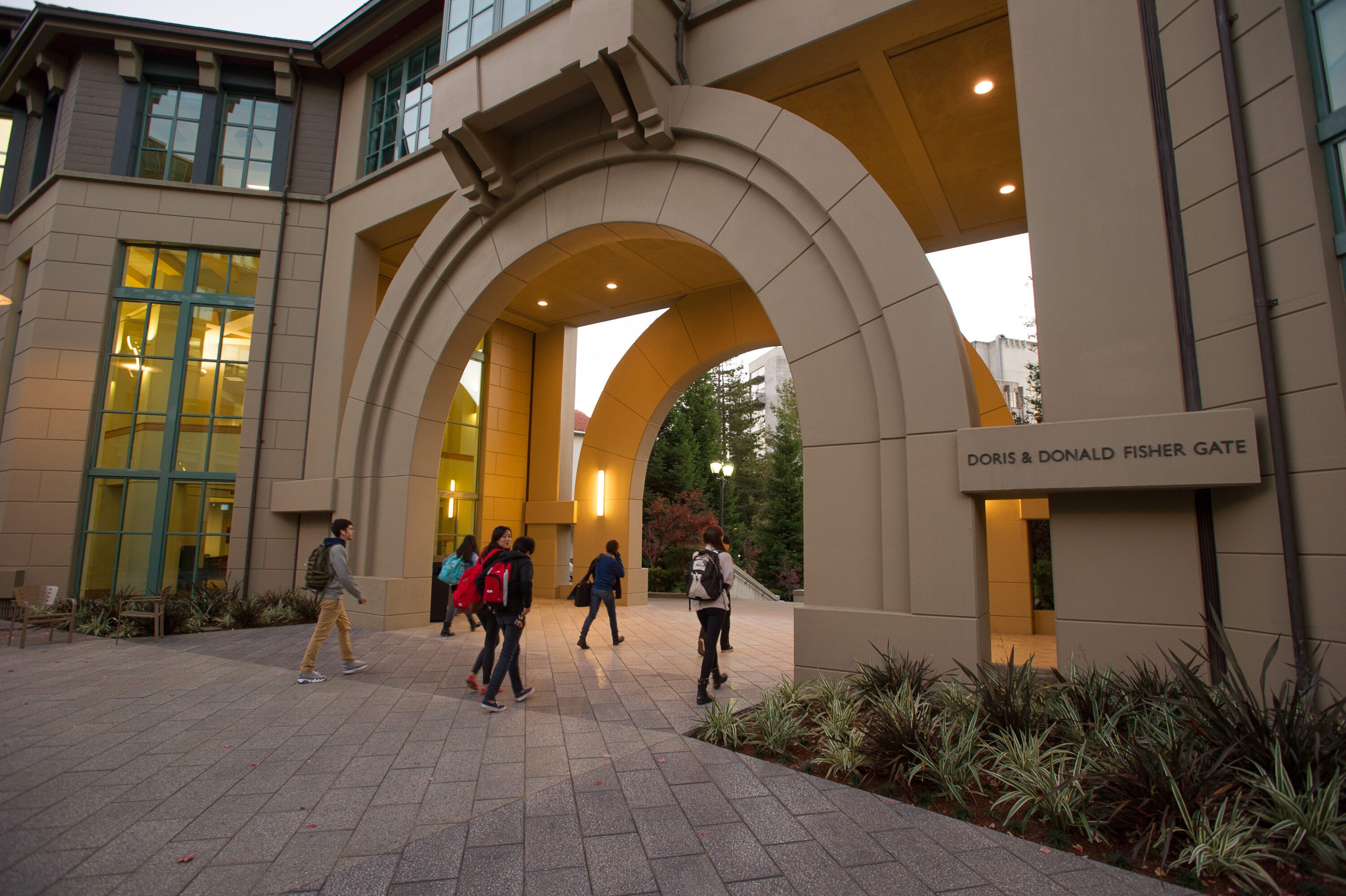 People walking through an archway