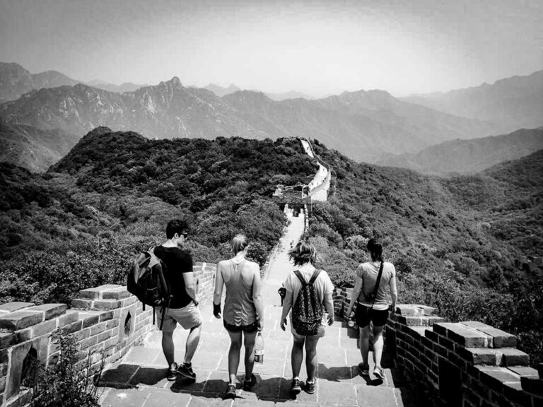 Four people walking on the Great Wall of China