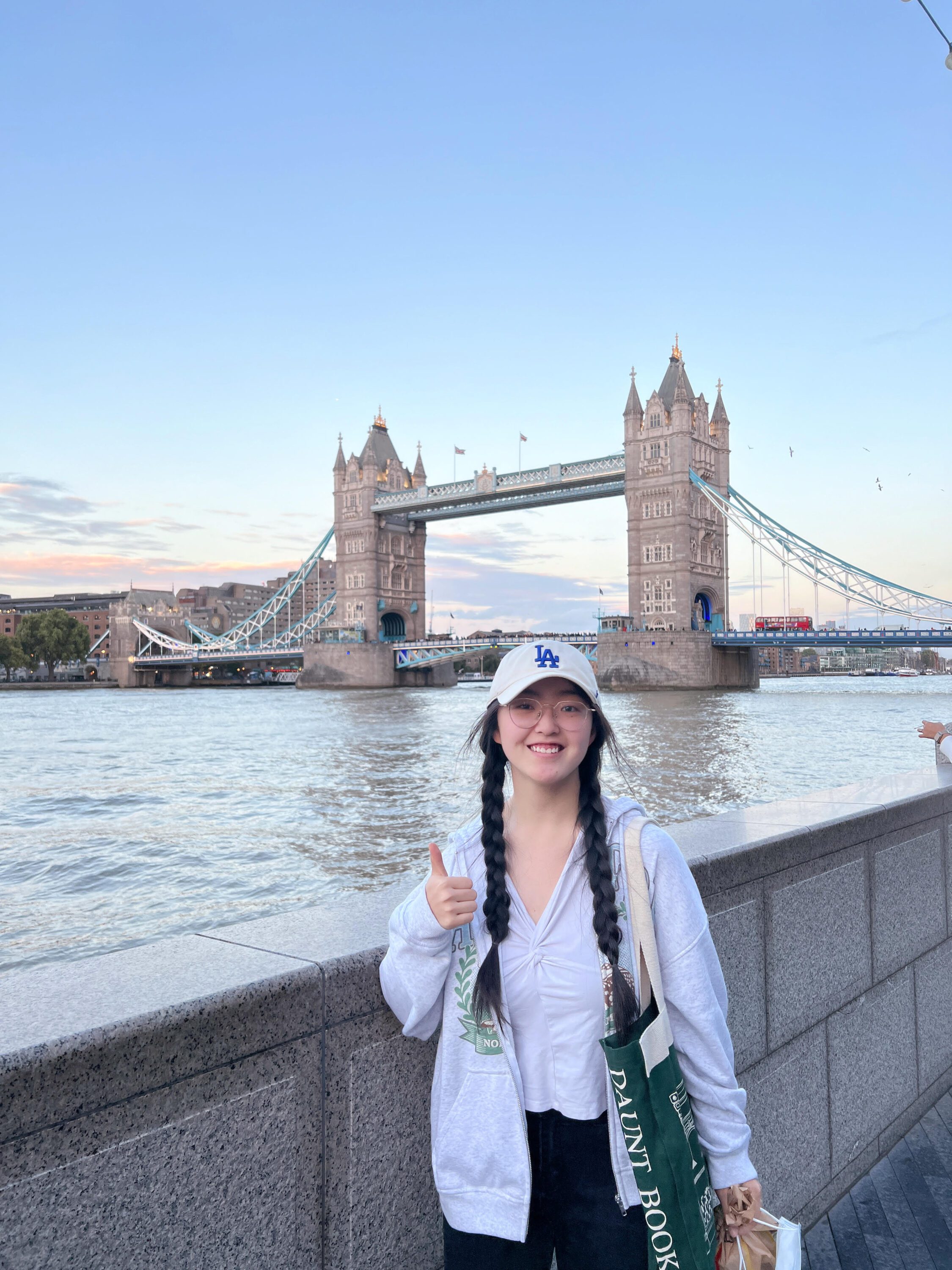 Lisa Hao, Class of 2026, posing in front of the London Bridge.