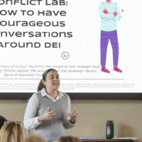 Person giving a presentation in front of a screen
