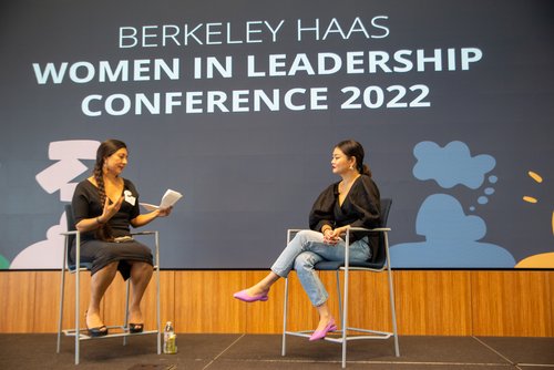 Two women on stage talking at the “Women in Leadership” conference.