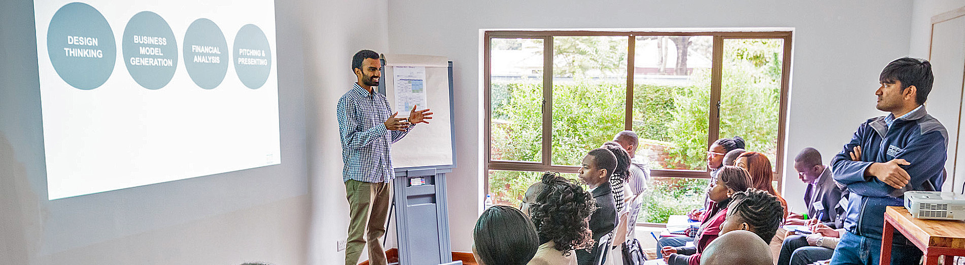 A man presenting to a room full of people