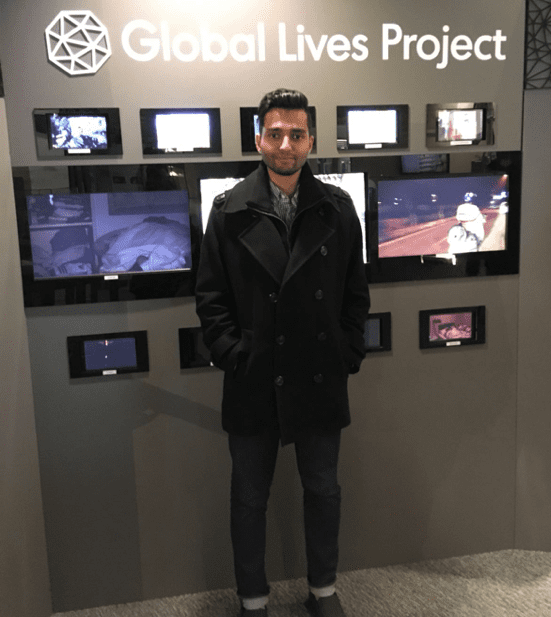 '19 MBA Gagan Dhaliwal in front of the Global Lives Project