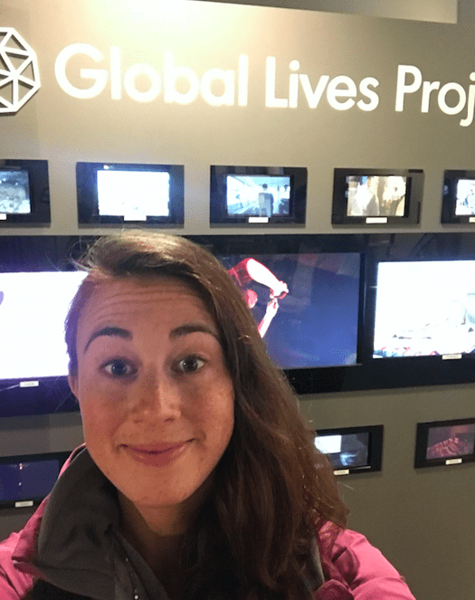'19 MBA Rachel Lee in front of the Global Lives Project Video Exhibit