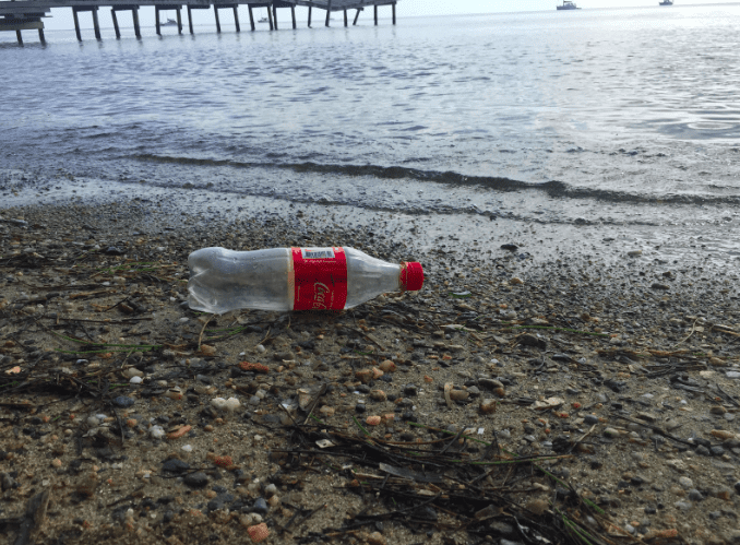 plastic coke bottle on the beach